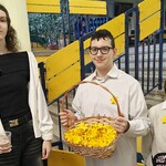 1 wolontariusze przy wejściu do szkoły z koszem papierowych  żonkili.jpg