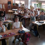 Dzieci podoszą w górę dyplomy i zakładki, które otrzymaly..jpg